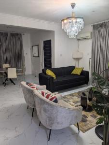 a living room with a couch and a table at Ivaeli Apartment in Lagos