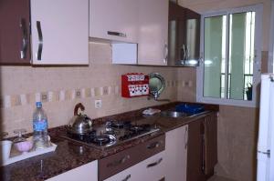 a kitchen with a stove top and a sink at إقامة جنان فاس in Fez