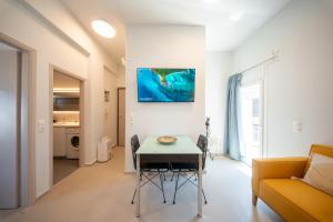 a living room with a table and a couch at Socratous Apartments in Mytilene