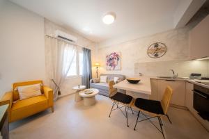a kitchen and living room with a table and chairs at Socratous Apartments in Mytilene