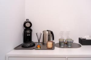 a counter with a coffee maker and cups on it at Maison les Mésanges in Flanthey +5 photos