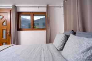 a bedroom with a bed and a window at Maison les Mésanges in Flanthey