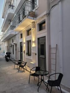 a group of tables and chairs outside of a building at City Center Suites in Karpathos