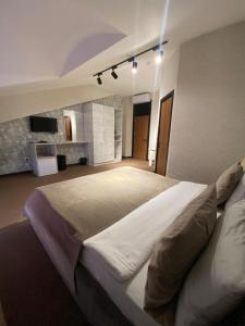 a bedroom with a large bed with lights on it at TALA ROOMS Hotel in Zaqatala