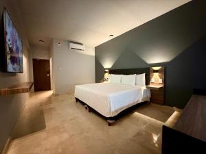 a bedroom with a large white bed in a room at San Germán in Guasave