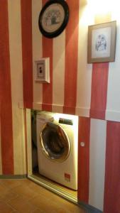 a washing machine in a room with red and white stripes at Altana Sul Tetto in Bologna