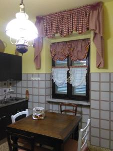 a kitchen with a wooden table and a window at Bargoncello in Riccò del Golfo di Spezia +157 photos