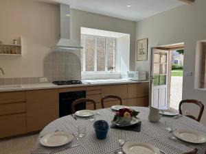 a kitchen with a table with plates on it at Maison Mélusine in Londigny