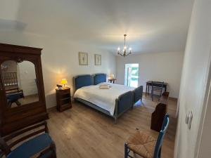 a bedroom with a bed and a mirror and a chair at Maison Mélusine in Londigny +15 photos