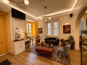 a living room with a couch and a table at Happy Holiday Sintra Guesthouse & Breakfast in Sintra
