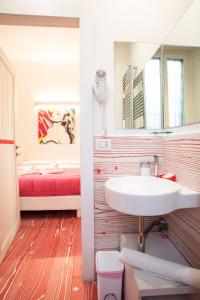 a bathroom with a sink and a mirror and a bed at Divine Bed & Breakfast in Rome +111 photos