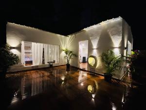 a white building with a clock on the side of it at The cosmos farm in Gurgaon