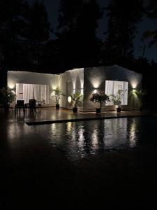 a night view of a house with lights at The cosmos farm in Gurgaon