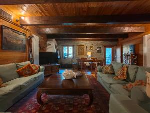 a living room with a couch and a table at Rifugio Escursionistico Vernin in Fenils