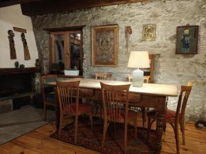a dining room with a wooden table and chairs at Rifugio Escursionistico Vernin in Fenils