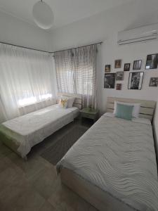 a bedroom with two beds and a window at Giannis house in Makri