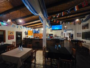 a dining room with two tables and a bar at Descanso de la Furia in San Carlos