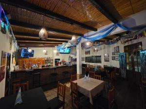 a dining room with a table and a bar at Descanso de la Furia in San Carlos