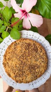 a cake in a white plate next to a pink flower at Il Cigno B&B in Capri +54 photos