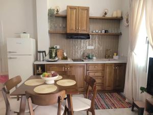 a kitchen with a table and chairs and a refrigerator at City Center Suites in Karpathos +12 photos