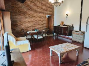 a living room with a couch and a table at El Quincho de Mariana in Balcarce