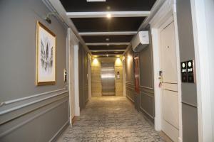 a corridor of a hallway with a hallwayiteratorythonythonythonythonythonythonython at THREE TREE Signature Hotel - G7 Markaz Islamabad in Islamabad