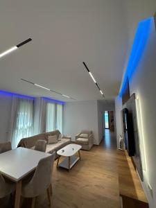 a living room with a couch and a table and a tv at Seaview Premium Apartment in Durrës