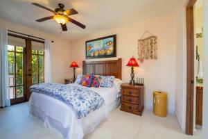 a bedroom with a bed and a ceiling fan at Stunning home - Amazing Mountain Views in Loreto +26 photos