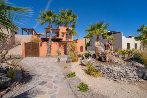 a house with palm trees and a driveway at Stunning home - Amazing Mountain Views in Loreto