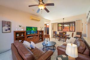 a living room with leather furniture and a flat screen tv at Stunning home - Amazing Mountain Views in Loreto