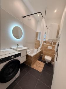 a white bathroom with a washing machine in it at Superbe 4 pièces luxueux in Fleury-les-Aubrais