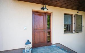 a front door of a house with a blue mailbox at Udobna hiša med vinogradi blizu Vinarium LEND - Comfortable Vineyard House near Vinarium Tower LEND in Lendava