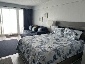 a bedroom with a large bed and a couch at Daytona Inn in Daytona Beach +38 photos