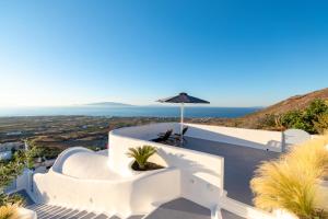 a villa with a view of the ocean at Sun Angelos Oia - Luxury Cave Suites in Oia