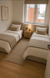 two beds in a room with two windows at 250m from Tommorowland in Boom