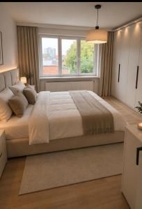 a bedroom with a large bed with a window at 250m from Tommorowland in Boom