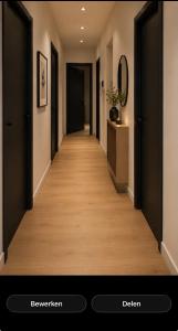 a hallway with black doors and a wooden floor at 250m from Tommorowland in Boom