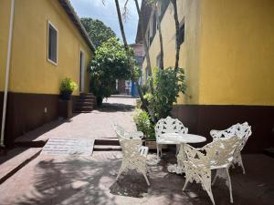 a table and chairs sitting next to a building at Pousada Vila Nativa in Arraial d'Ajuda +46 photos