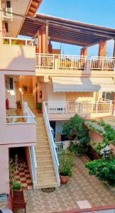 an apartment building with stairs and a balcony at Aurora House in Sarti
