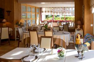 a restaurant with tables and chairs with a chicken on them at Auberge de la Terrasse in Villersexel