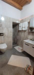 a bathroom with a toilet and a sink at Hacel's Stairs in Ordu