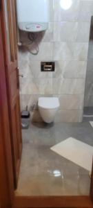 a bathroom with a white toilet in a room at Hacel's Stairs in Ordu