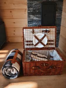 two baskets sitting on the floor next to a fireplace at Podhalańskie Chaty in Rokiciny Podhalanskie +16 photos