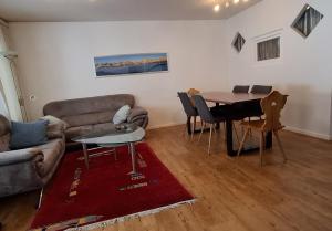 a living room with a couch and a table at Ferienwohnung in den Flumserbergen in Flumserberg