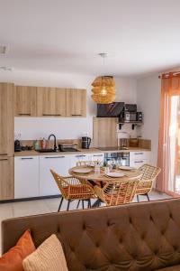 a kitchen with a table and chairs in a room at Terracotta house in Sorgues