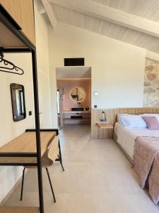 a bedroom with a bed and a mirror at Izel Villas in Skinária +40 photos