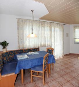 a living room with a table and a couch at Haus Muntschnei in Sankt Gallenkirch