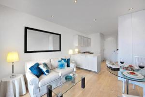 a living room with a white couch and a glass table at Brentano Elegante in Mezzegra