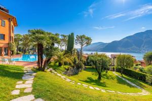 a villa with a view of the water and mountains at Brentano Elegante in Mezzegra +9 photos
