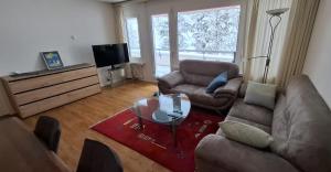a living room with a couch and a glass table at Ferienwohnung in den Flumserbergen in Flumserberg